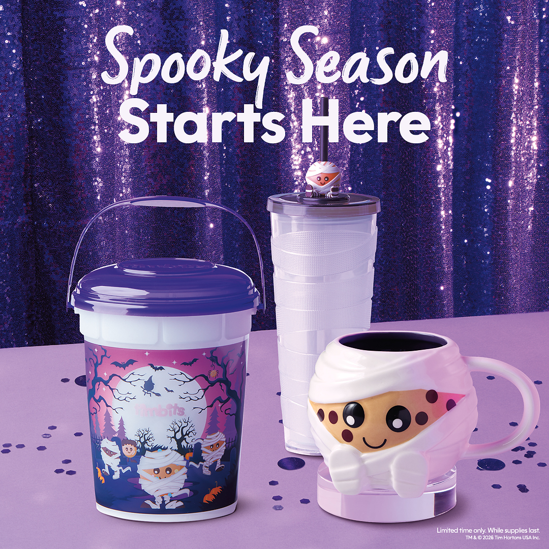 Official Tim Hortons 2026 Halloween merchandise photo with a purple-lidded Timbits mummy bucket, tumbler and mug